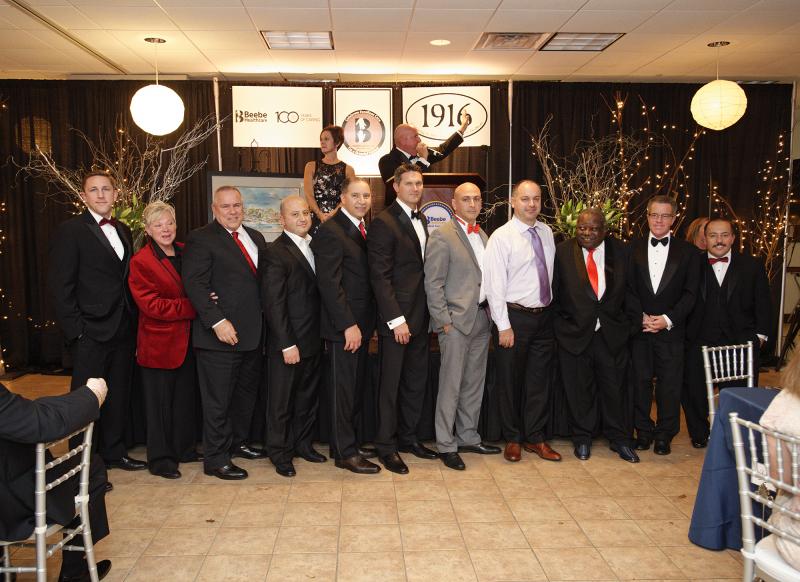 Gathered at the Beebe Thanksgiving Ball are in front (l-r) Dr. Sean Ryan; Denise Pecora, nurse practitioner; Dr. Kenneth Sunnergren; Dr. Firas El Sabbagh; Dr. R. Alberto Rosa; Dr. Robert Myers; Dr. Mouhanad Freih; Dr. Dimitros Barmpouletos, Dr. M. L. Ray Kuretu; Dr. Christopher Genco; Dr. Carlos Neves. In back are Cheryl Davidson and Tom Protack, vice president of development for the Beebe Medical Foundation. SUBMITTED PHOTO